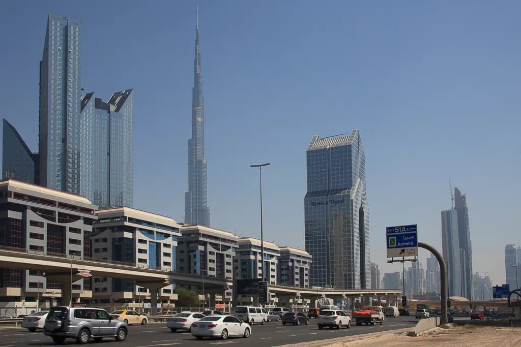 Office towers along Sheikh Zayed Road in Dubai with traffic in the foreground