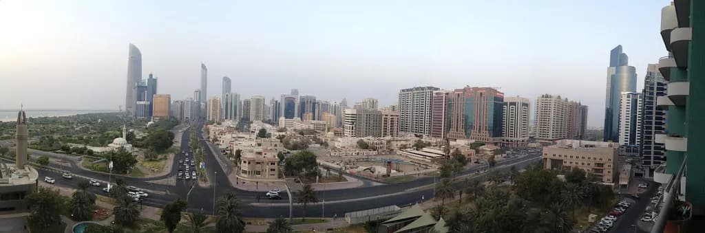 Panorama of Abu Dhabi city blocks and office towers along the coast