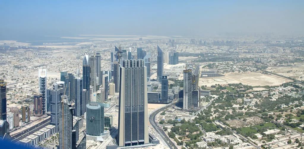 Aerial view of office towers along Sheikh Zayed Road and the wider Dubai cityscape