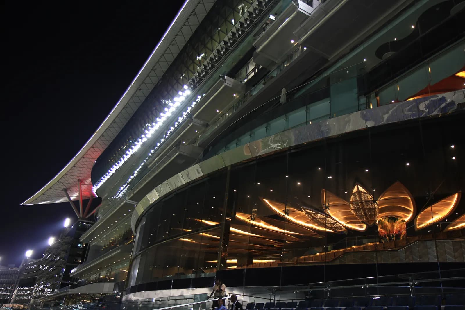 The Meydan grandstand building lit up at night in Meydan City, Dubai, home of Meydan Free Zone