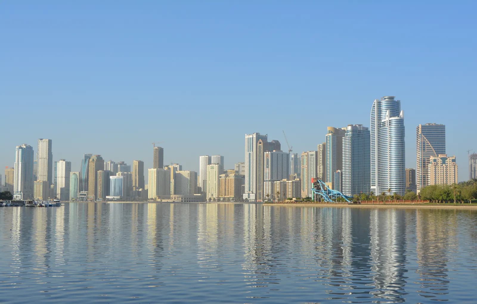 Sharjah city skyline with high-rise towers beside the water