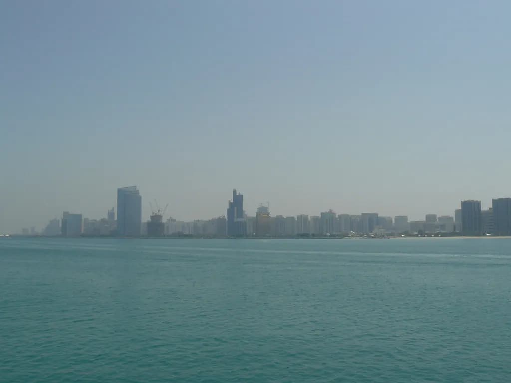 The Abu Dhabi skyline seen across the water on a hazy day