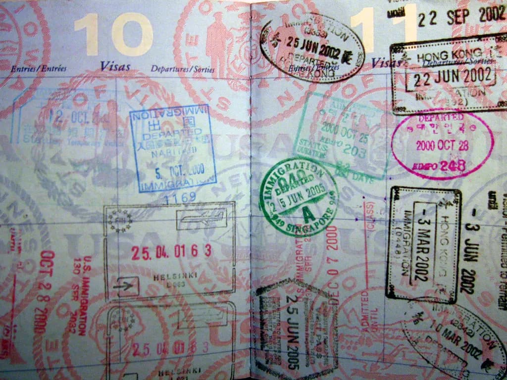 Passport pages covered in entry and exit stamps from several countries