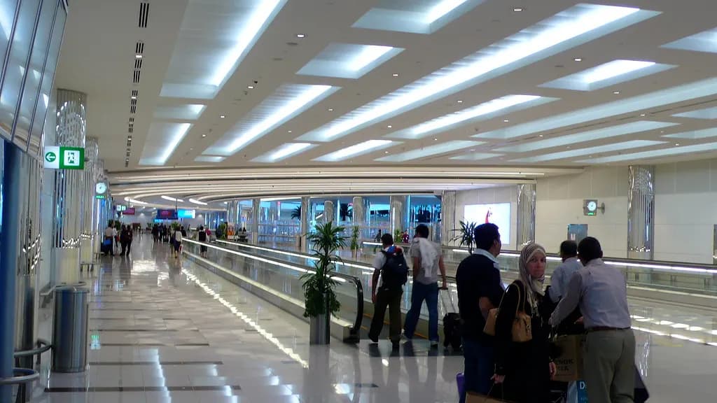 Travellers walking through the arrivals hall of Terminal 3 at Dubai International Airport