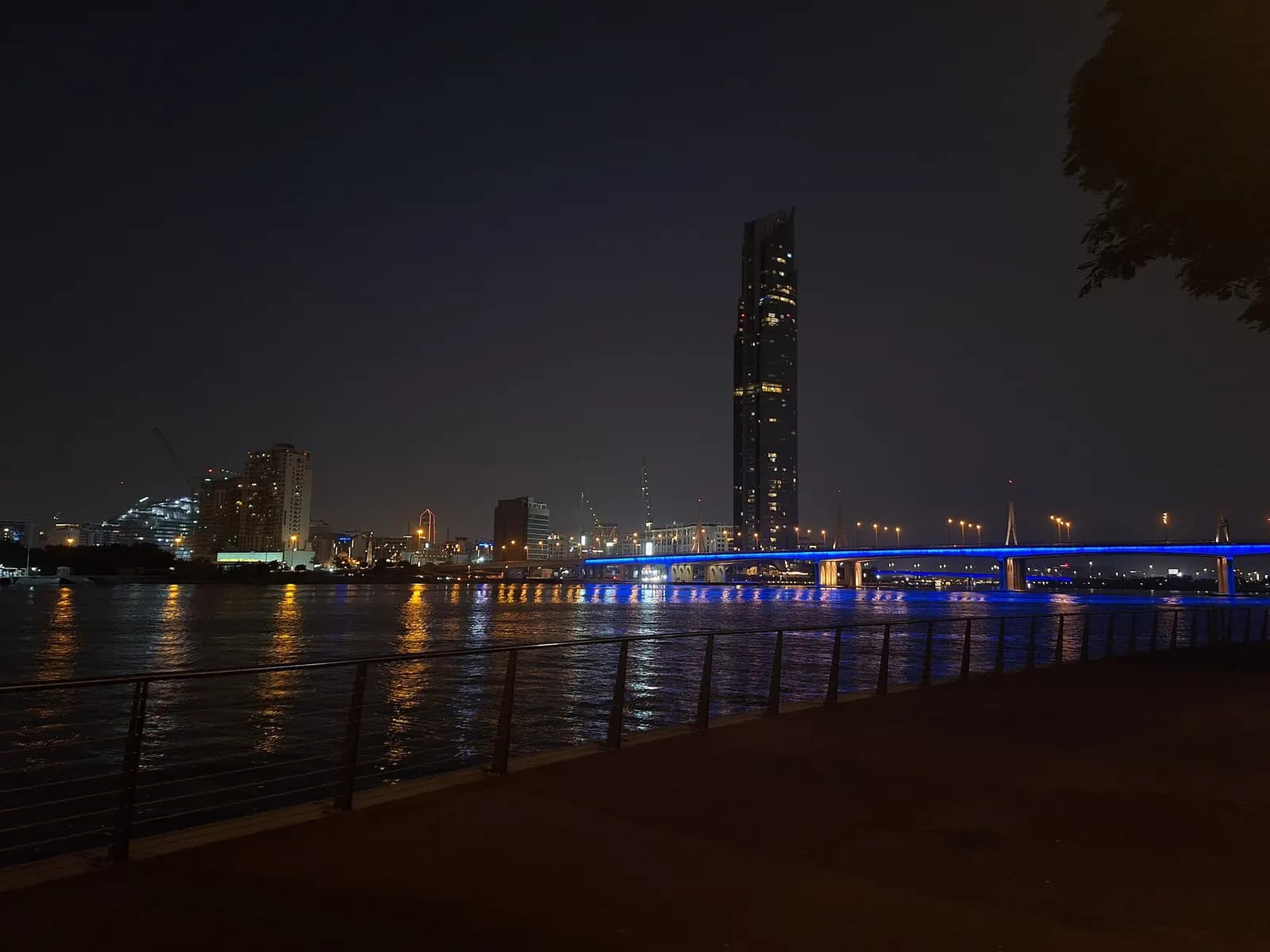 Business Bay towers and the illuminated Business Bay Crossing over Dubai Creek at night