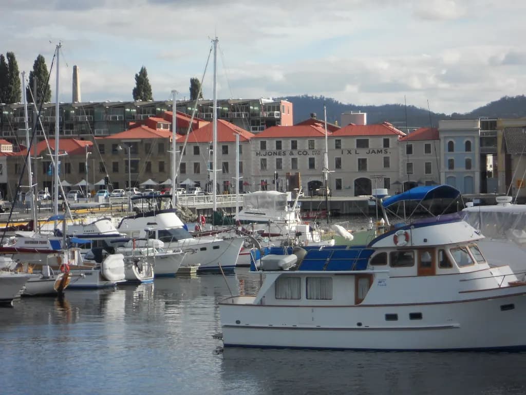 Hobart waterfront with boats moored in front of sandstone buildings