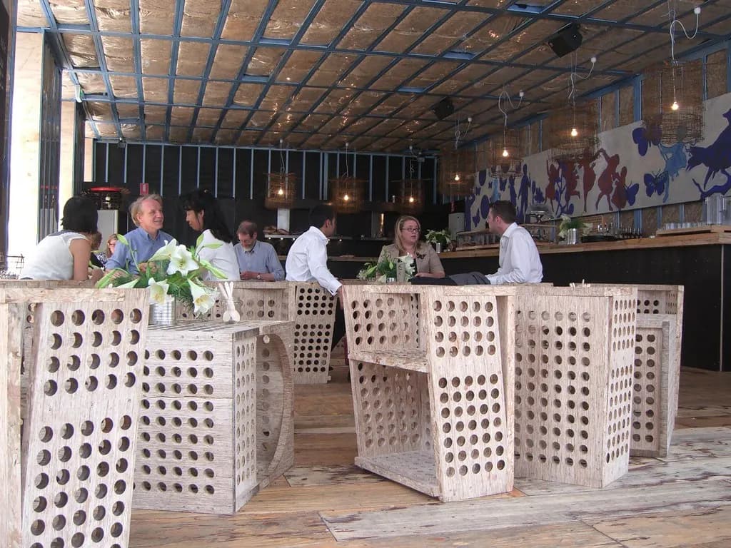 Diners seated at wooden tables and a long counter inside a café at Federation Square, Melbourne