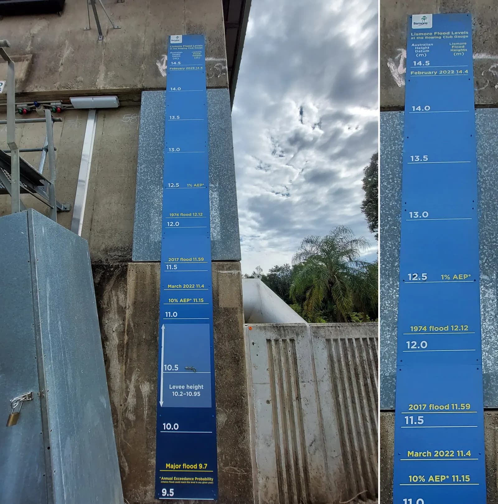 Blue flood-height gauge on a pole in Lismore marking historic flood levels, including the record March 2022 flood