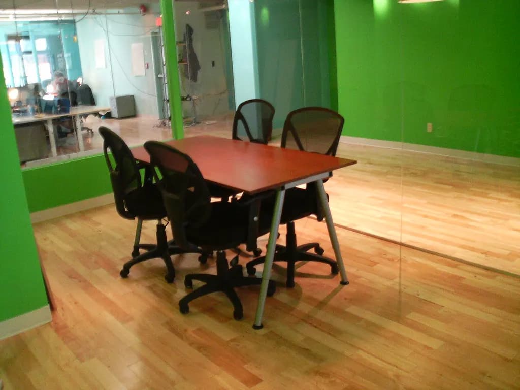 Small company boardroom with a long timber table and office chairs