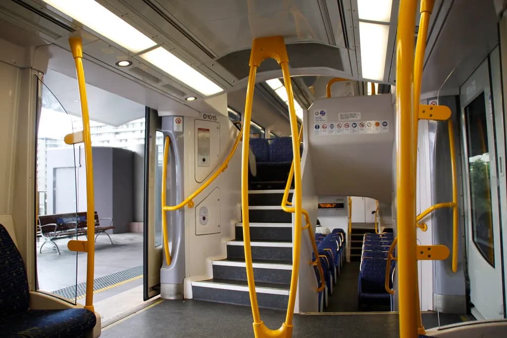 Inside a Sydney suburban double-deck train carriage with empty seats