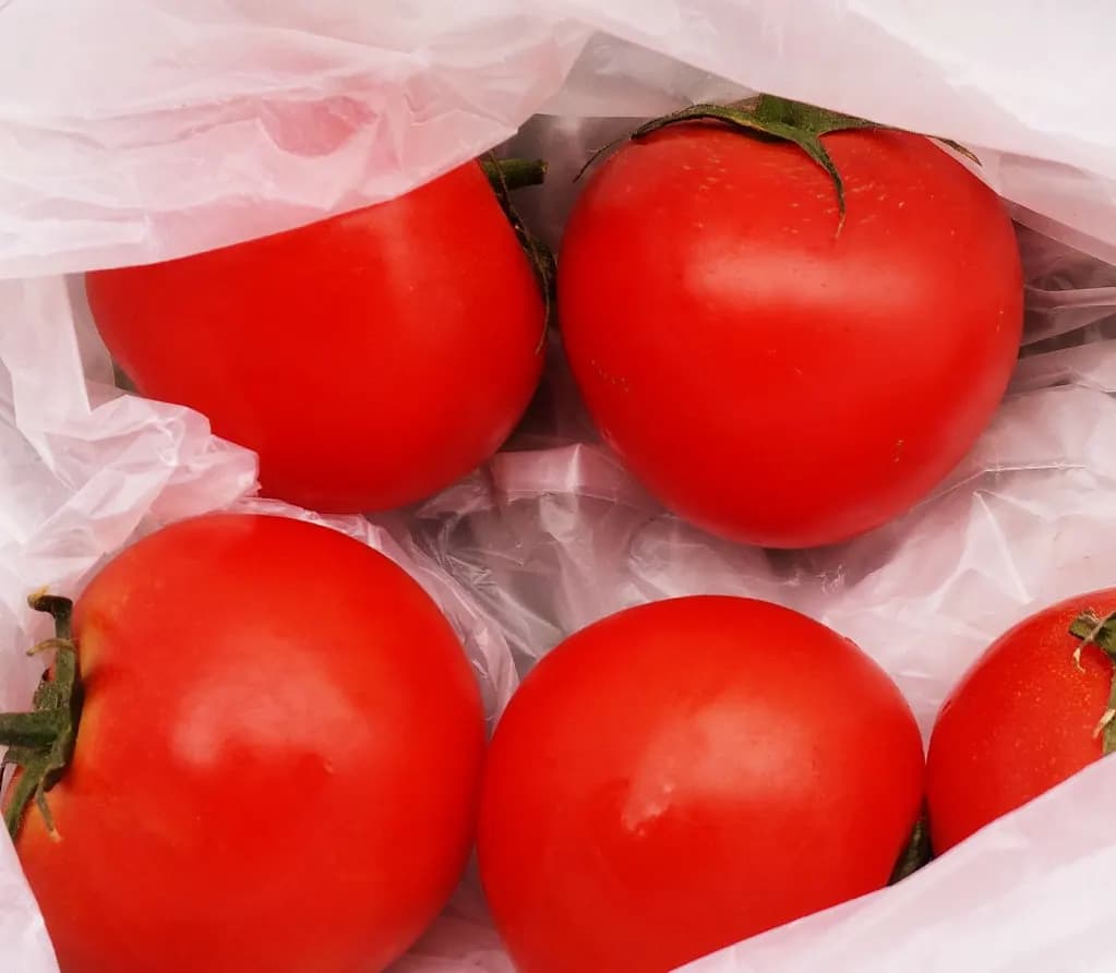 Crates of fresh tomatoes for sale at a stall in Queen Victoria Market, Melbourne