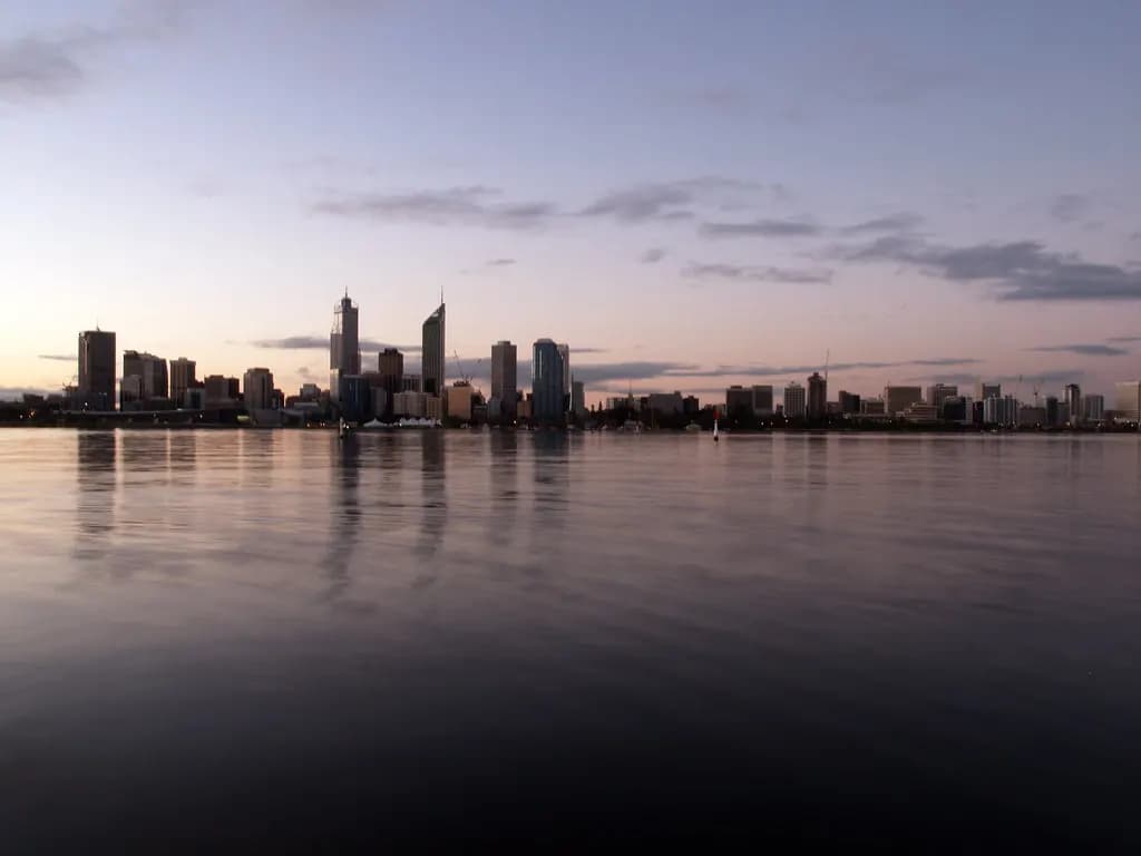 The Perth city skyline reflected in the Swan River at dusk