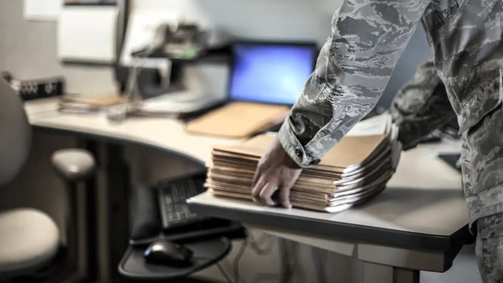 Stacks of paper files and documents on a desk