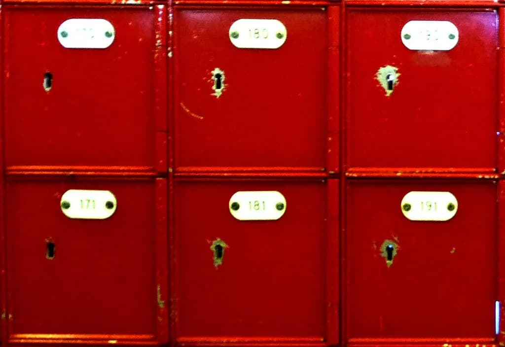 Rows of numbered red post office boxes