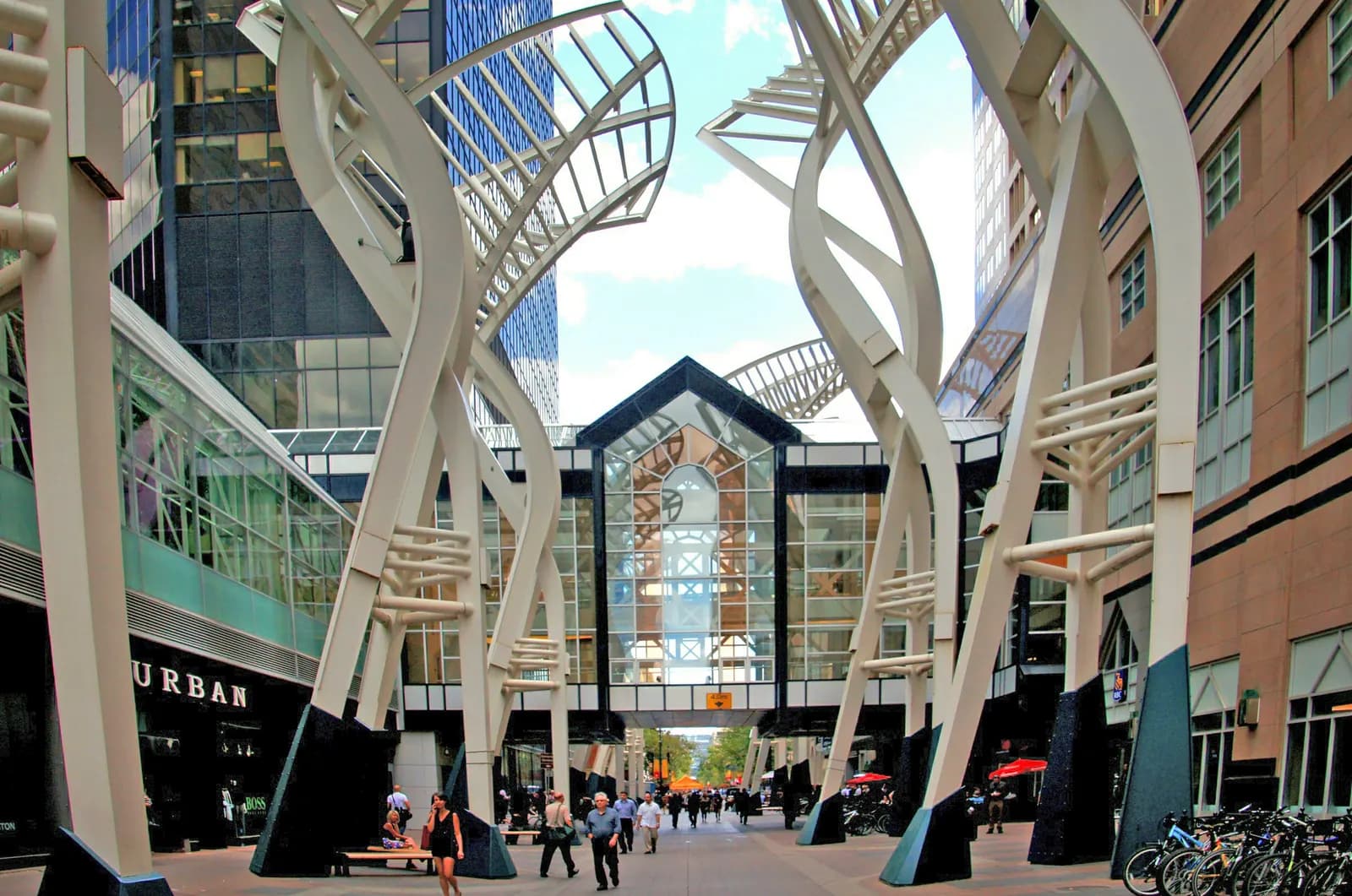 Pedestrian mall on Stephen Avenue in downtown Calgary with shops under white steel arches