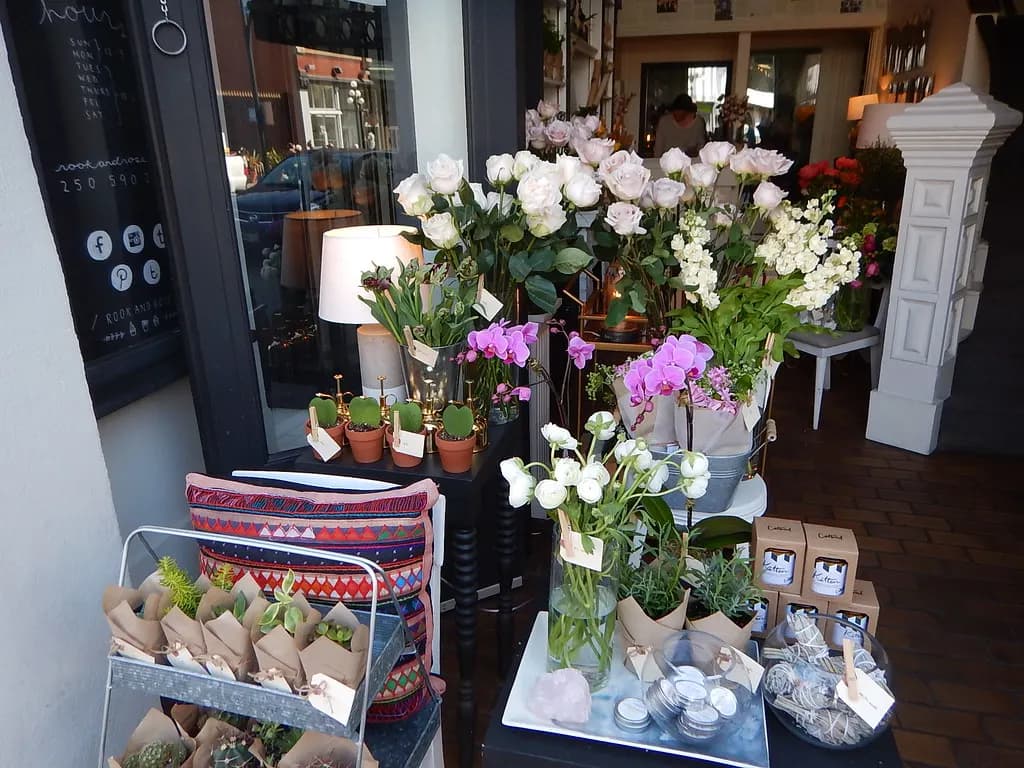 Potted orchids, flowers and succulents displayed outside a small florist's shop in downtown Victoria, B.C.