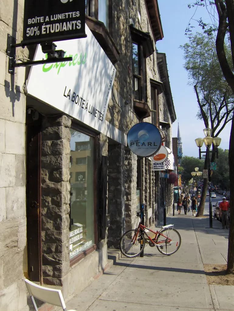 Independent shops with French-language signs in stone buildings on Rue Saint-Denis, Montreal