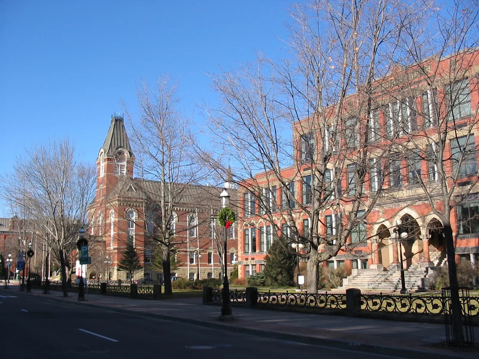 Brick and sandstone buildings along a tree-lined street in downtown Fredericton, New Brunswick