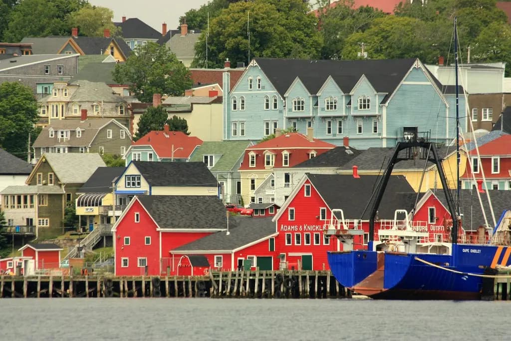 Brightly painted waterfront buildings in Lunenburg, Nova Scotia, beside the harbour