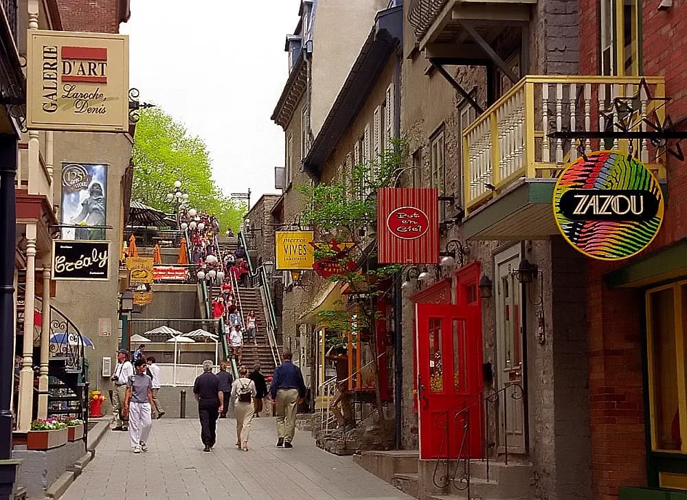 Small shops with French-language signs along the narrow Rue du Petit-Champlain in Quebec City