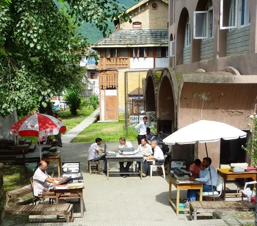 Scribes typing letters on typewriters outside the post office in Mandi, Himachal Pradesh