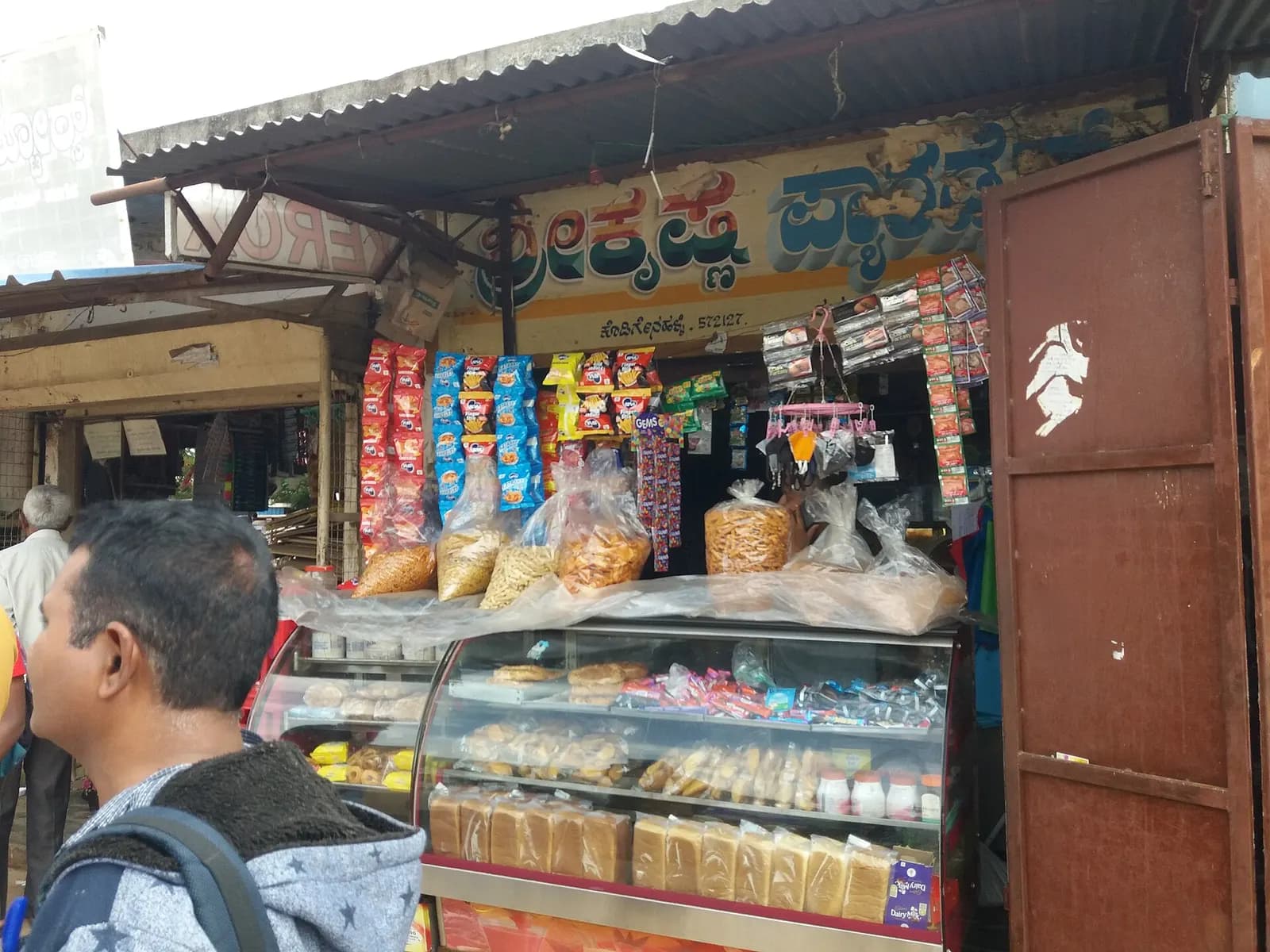 A small provision and bakery shop in Karnataka with snacks, biscuits and packaged goods on display