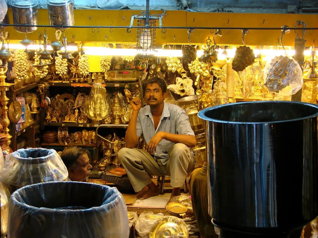 A shopkeeper in his brass and steel utensils shop in a Madurai market
