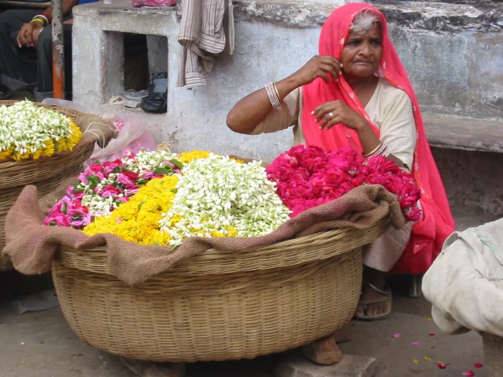 A woman selling marigold garlands and flowers from her stall in Pushkar, Rajasthan