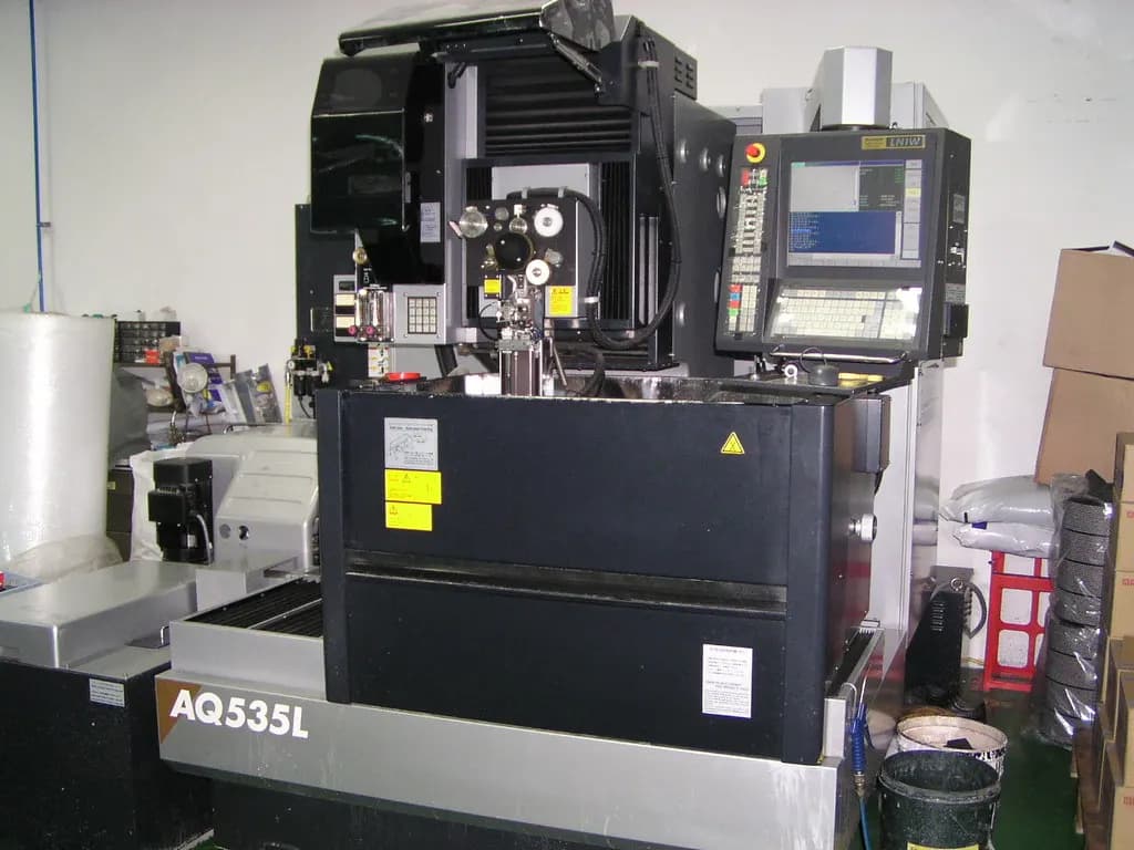 A Sodick AQ535L CNC wire-cut EDM machine with its control screen in a tool room