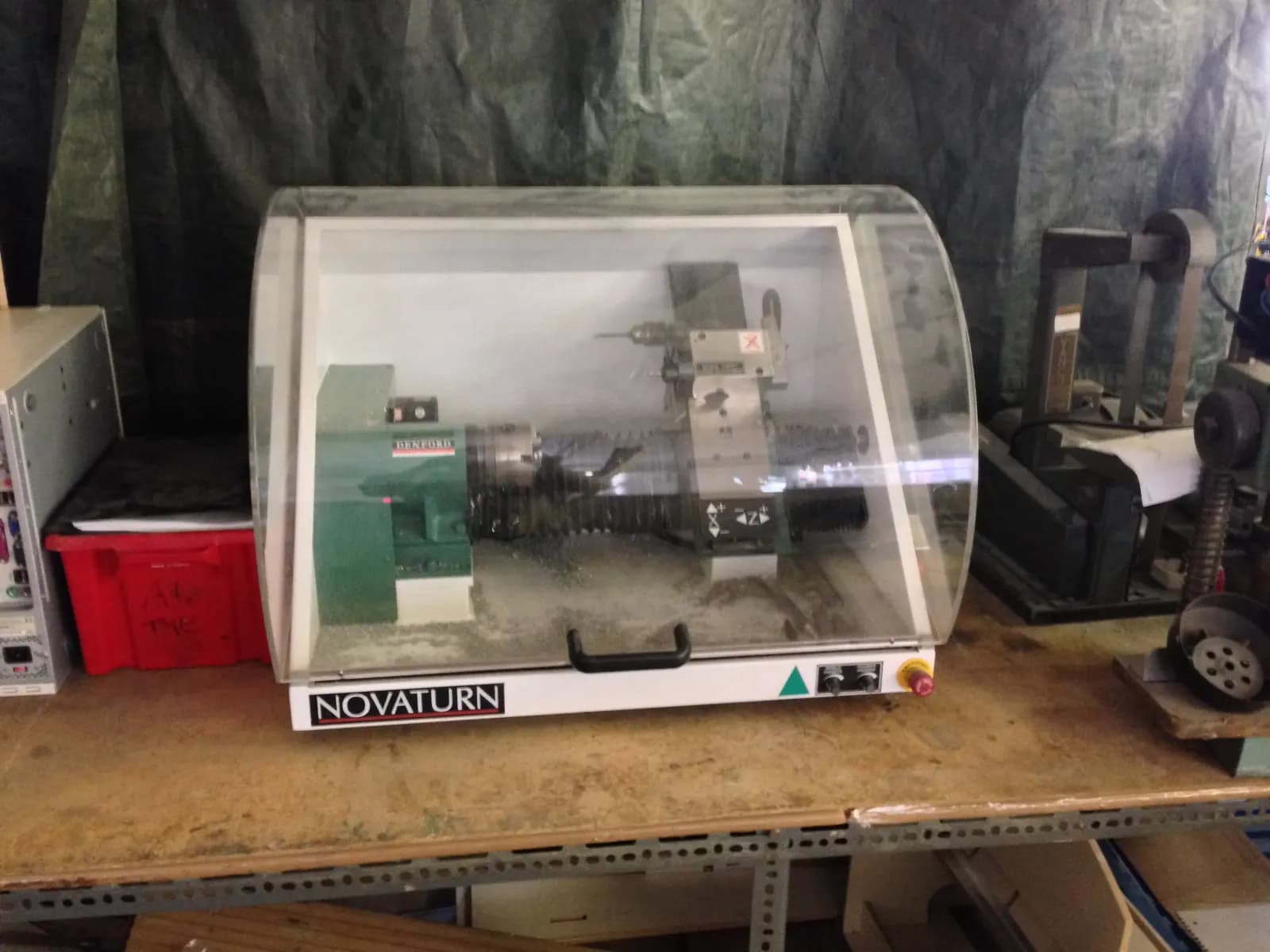 A small Denford Novaturn bench-top CNC training lathe inside a clear safety enclosure