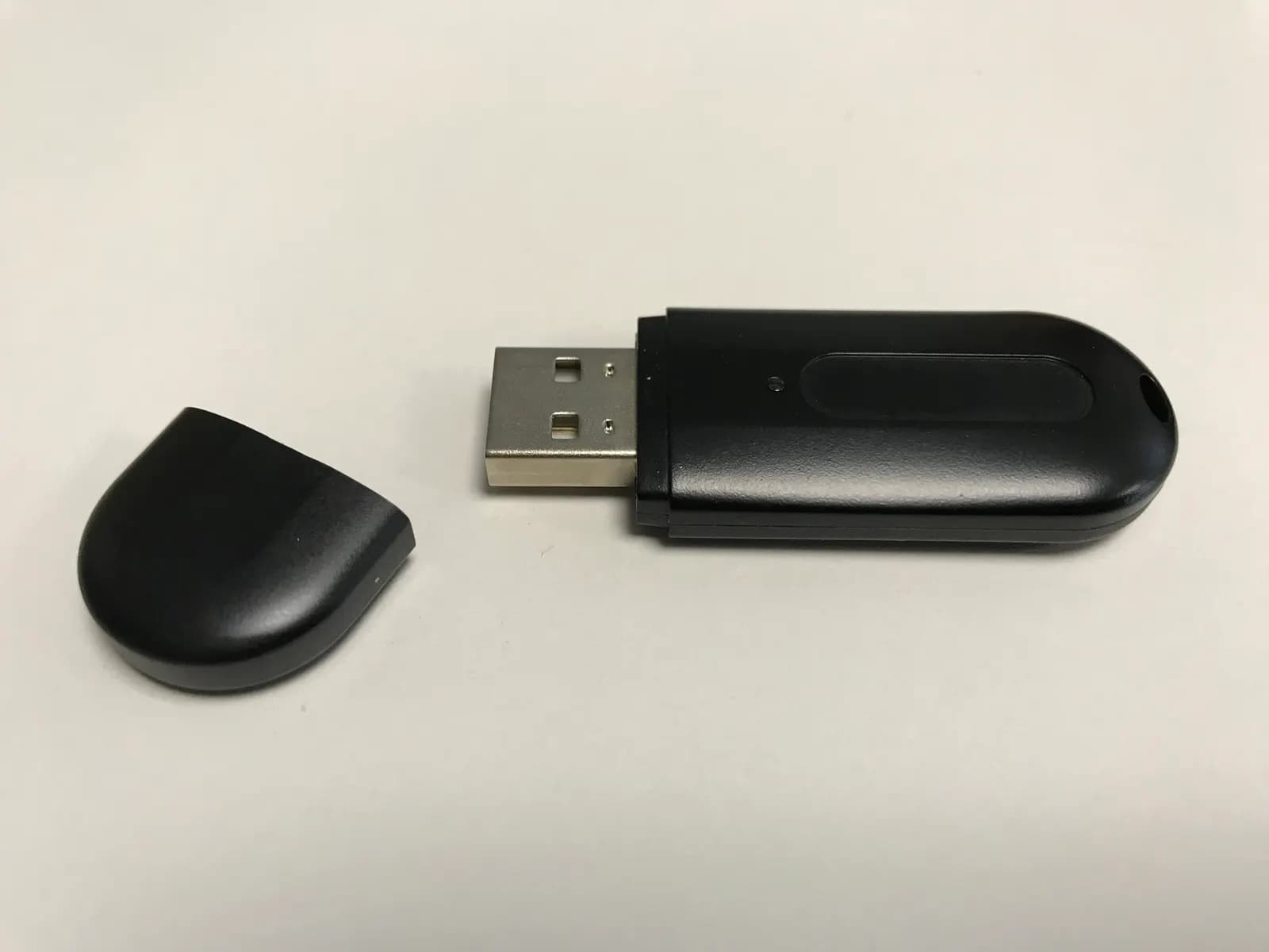 A black USB cryptographic token with its cap removed, the type used to hold a digital signature certificate