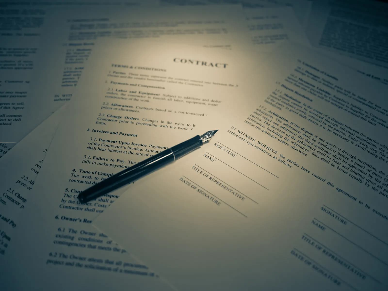 A signature being added at the foot of a printed document