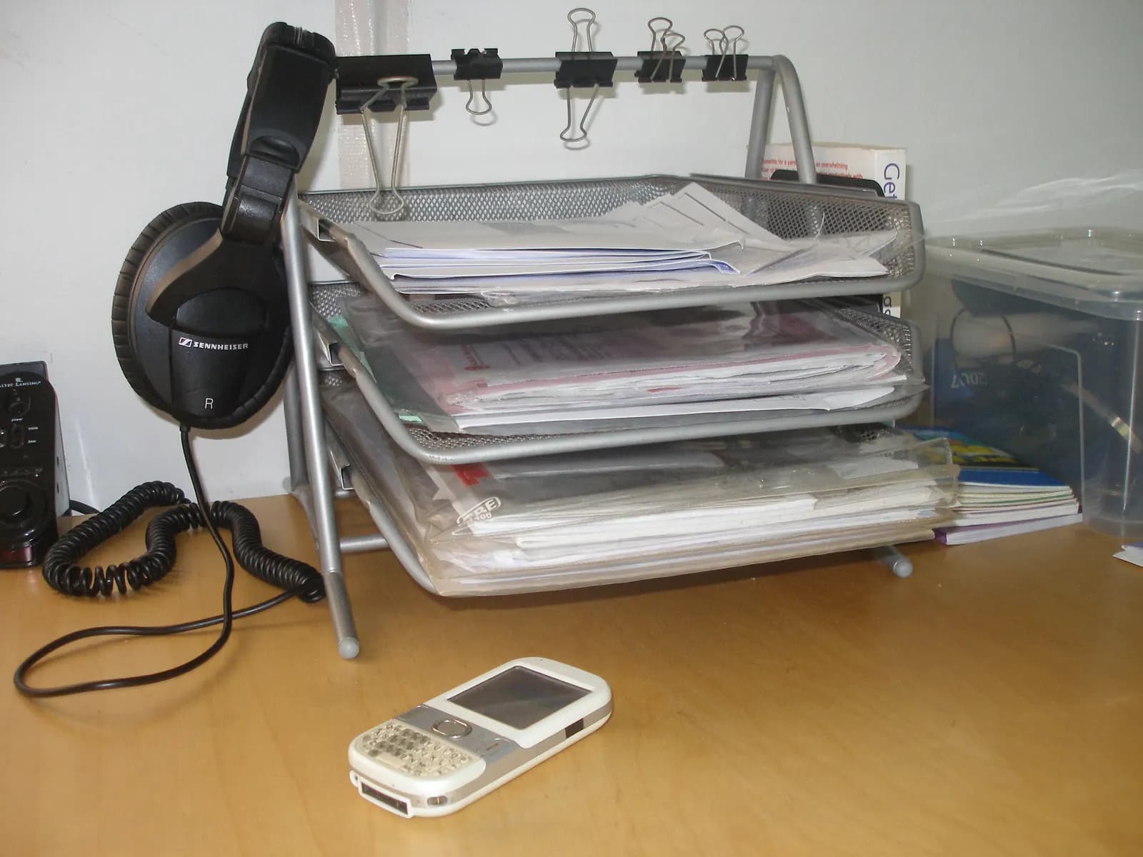 Stacked office inbox trays holding papers and files