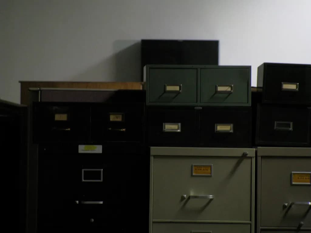 Old metal filing cabinets stacked against an office wall