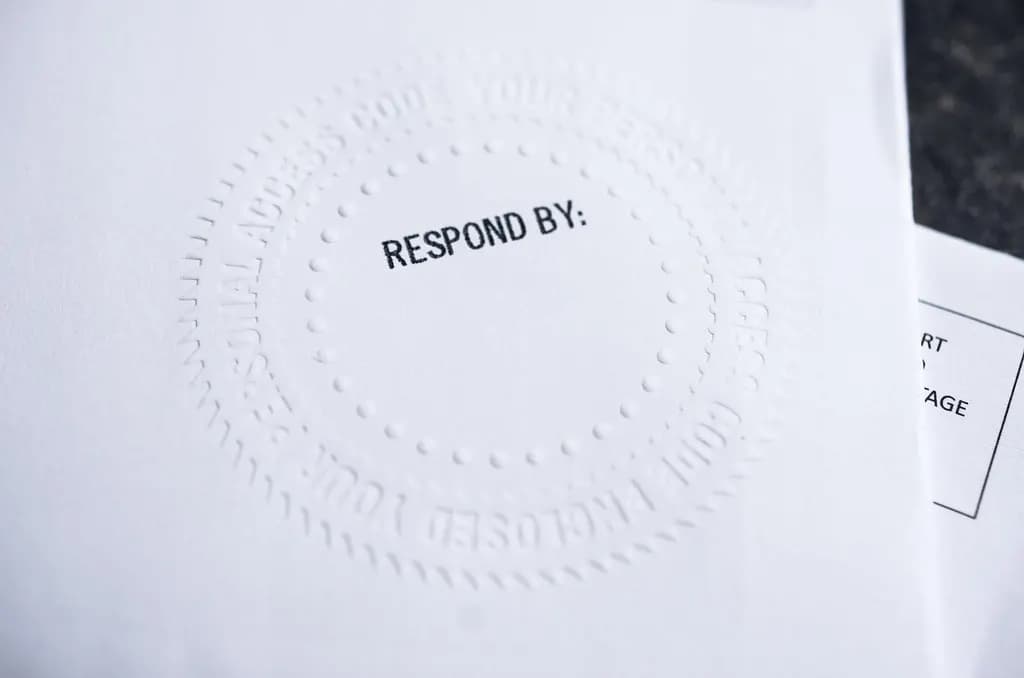 Embossed official envelope stamped with the words Respond By