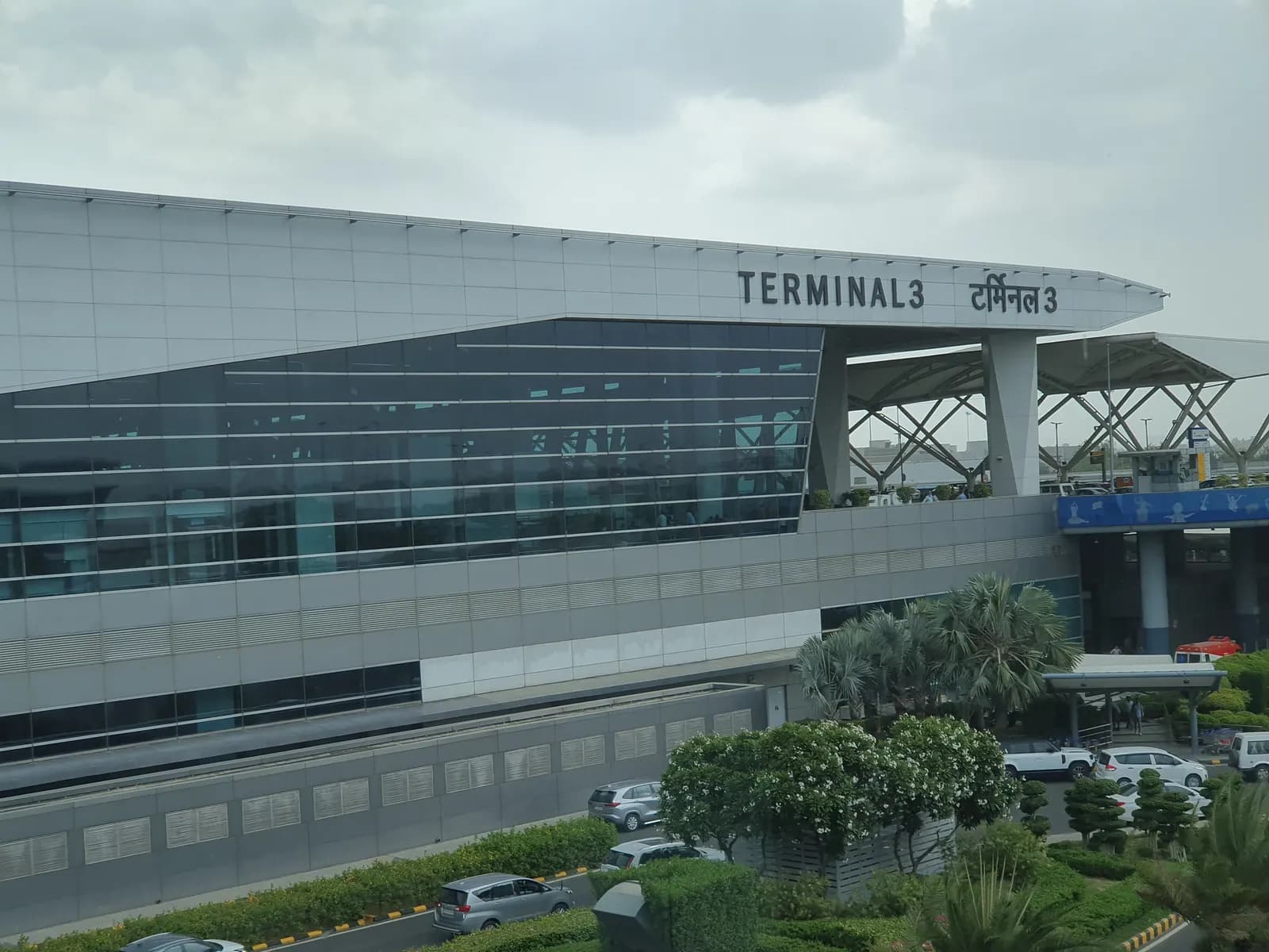 Exterior of Terminal 3 at Delhi's Indira Gandhi International Airport with the terminal name in English and Hindi