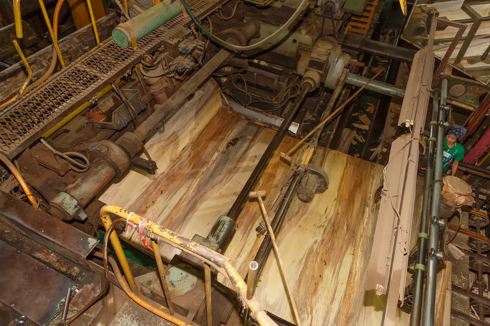 A rotary peeling lathe in a plywood factory turning a log into a continuous sheet of wood veneer