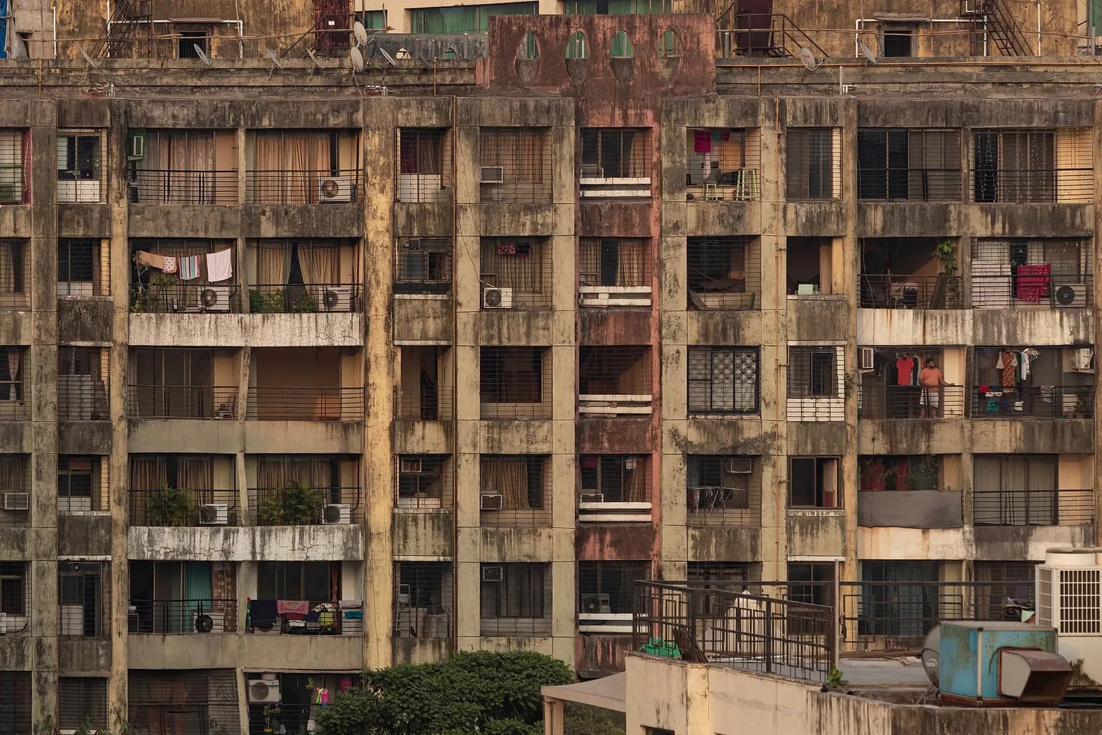 An older residential apartment block in Andheri East, Mumbai, with balconies, window grilles and AC units