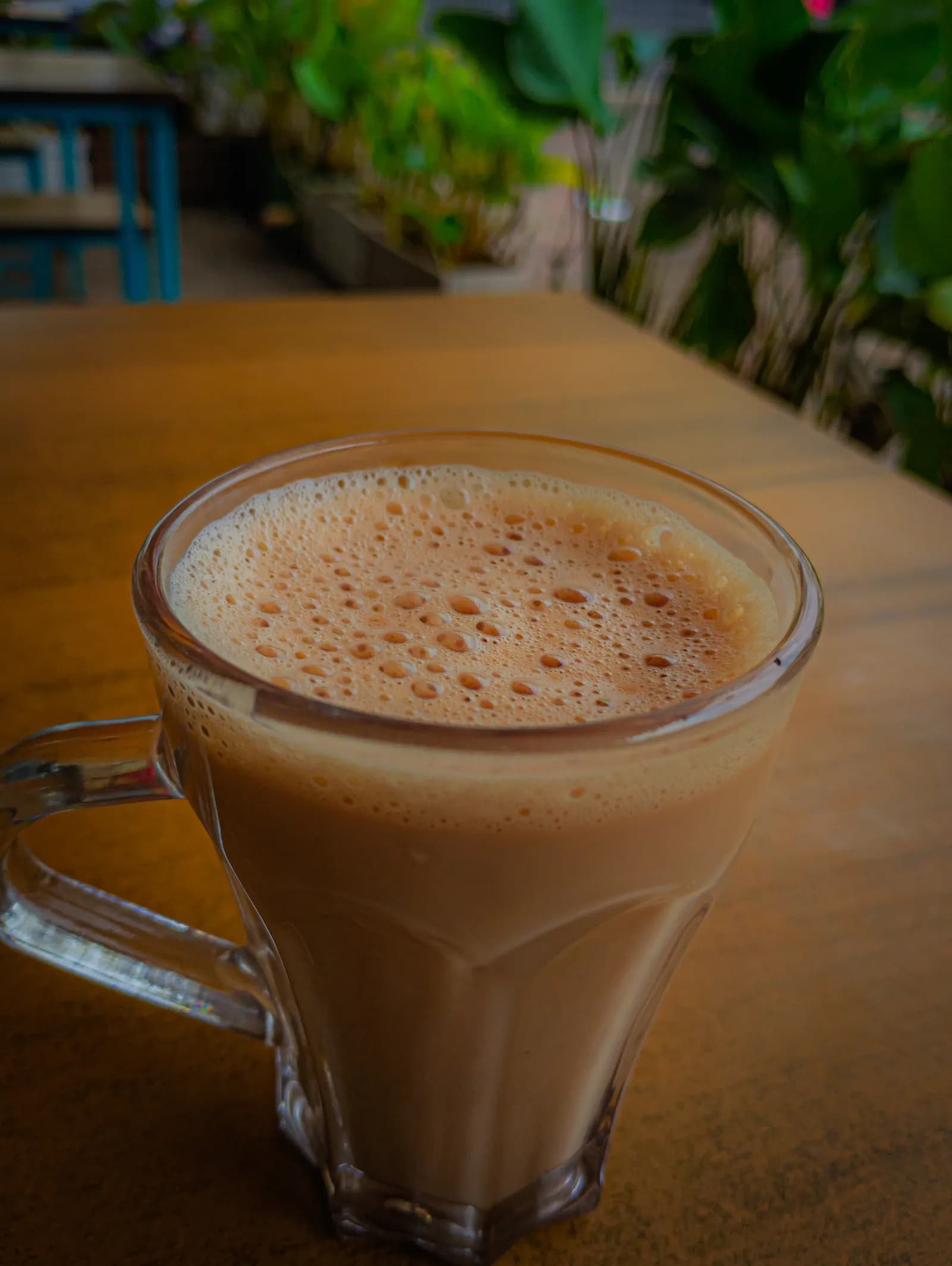 A glass of milky Kerala-style chai on a table