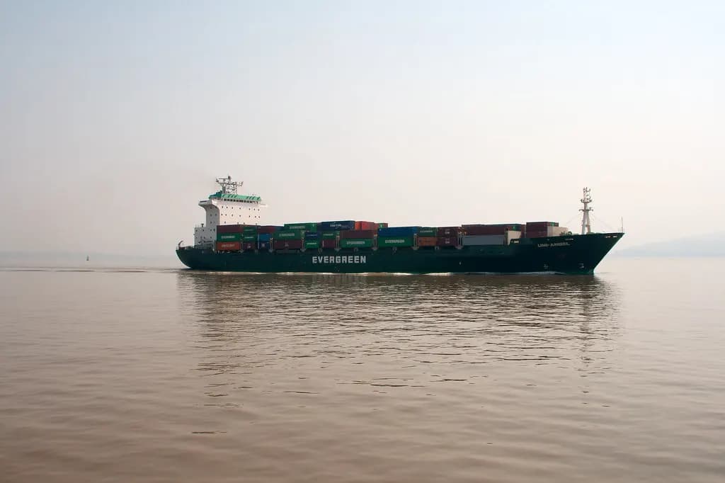 Loaded container ship sailing into Mumbai harbour in the morning haze