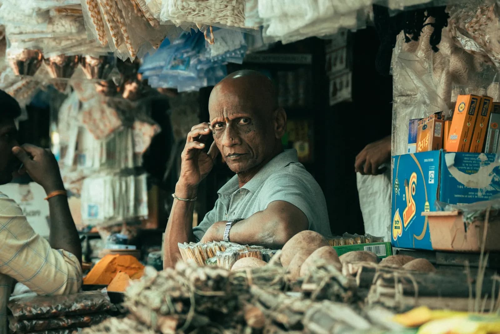 A shopkeeper at his counter in Chickpet Bazaar, Bengaluru