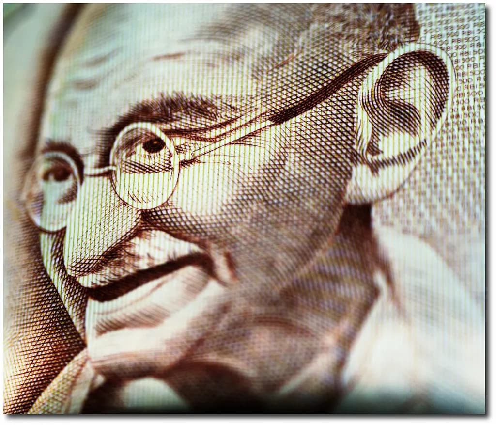 Close-up of the Mahatma Gandhi portrait printed on an Indian rupee banknote
