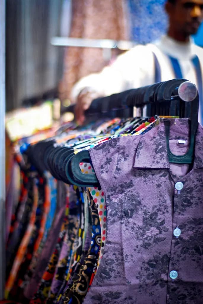 Printed shirts on hangers on a rack in a clothing shop