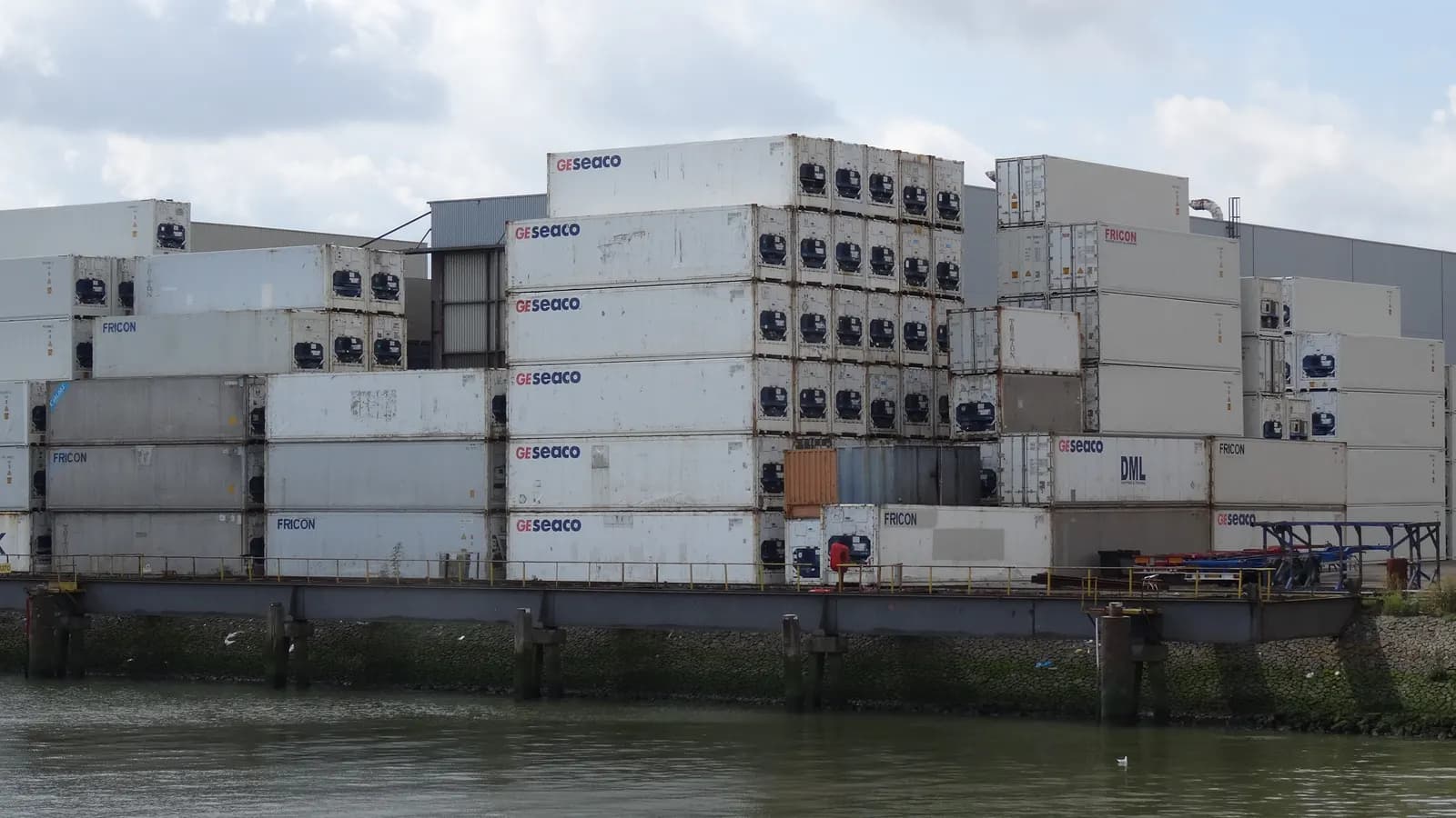 Rows of stacked shipping containers at a container terminal