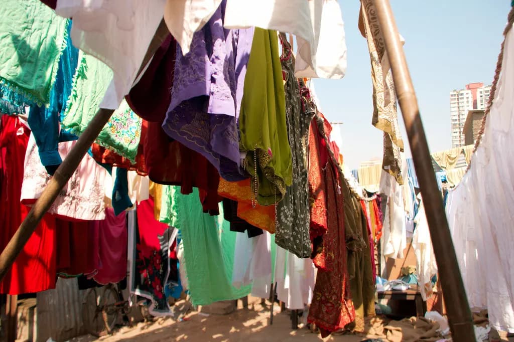 Colourful clothes and saris hanging on lines to dry at an open-air washing ghat in Mumbai