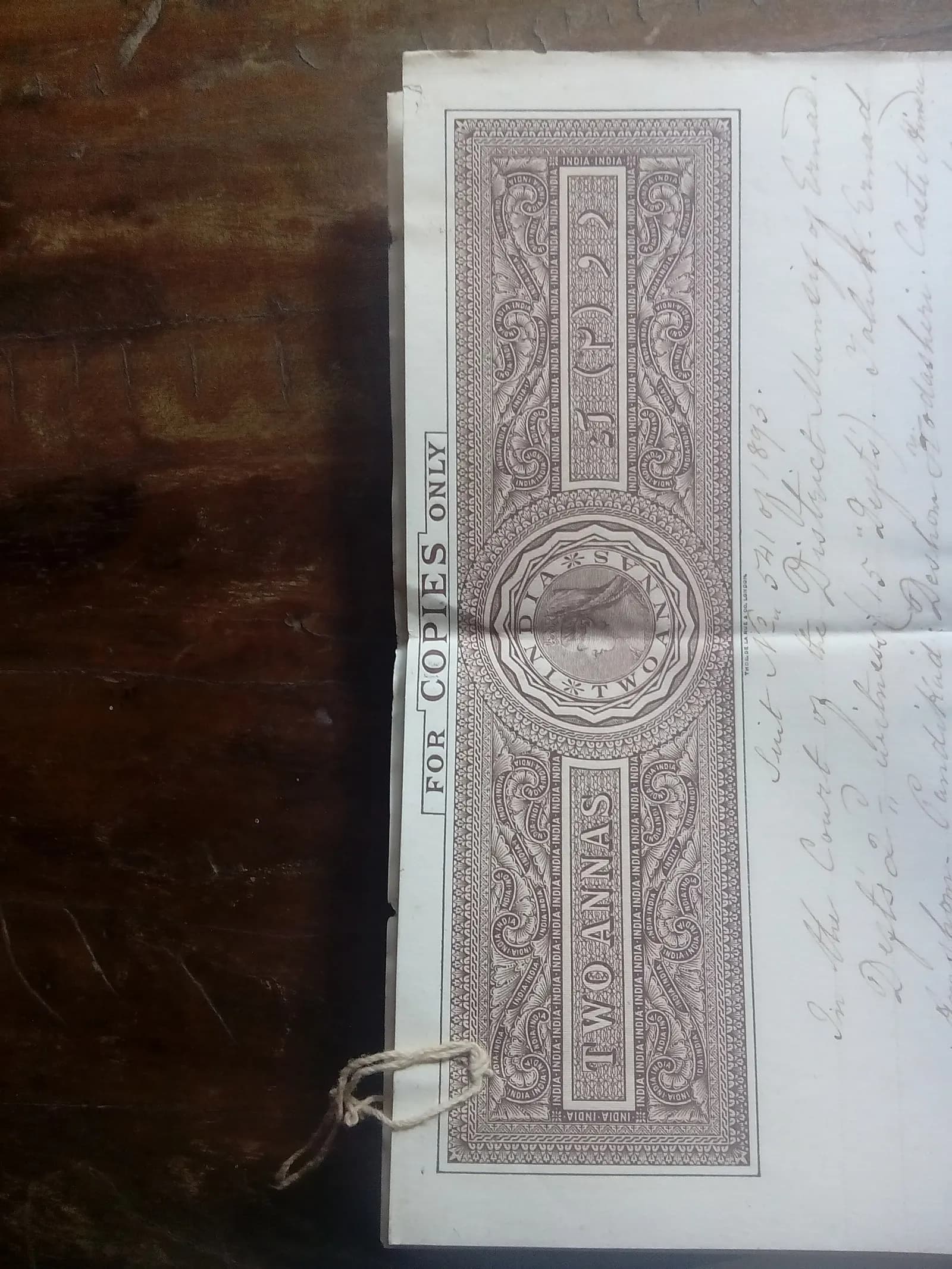 An 1895 Indian stamp paper with a printed 'Two Annas' duty panel and handwritten text