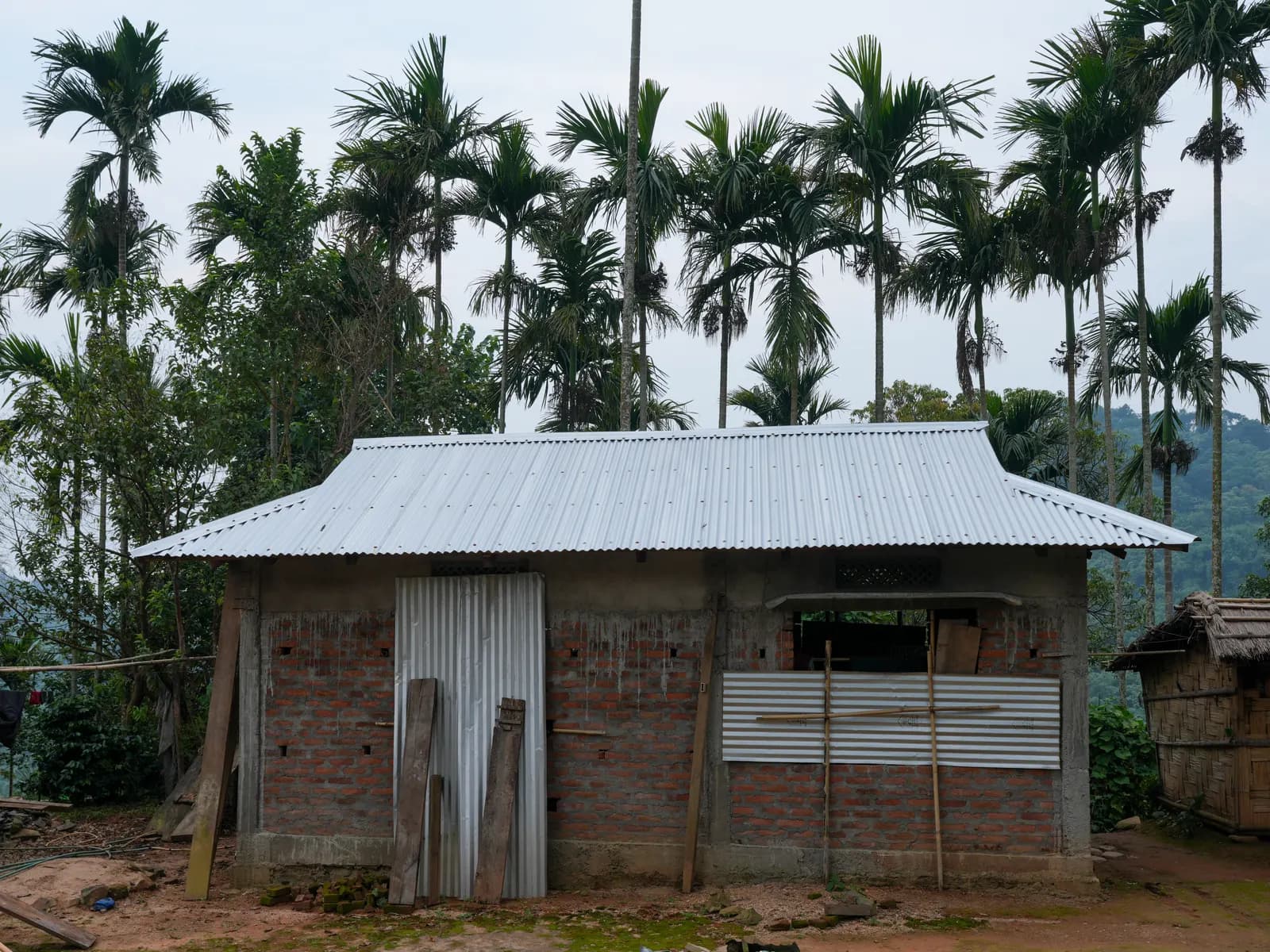 A concrete and brick house under construction at Sasatgre in the Garo Hills, Meghalaya