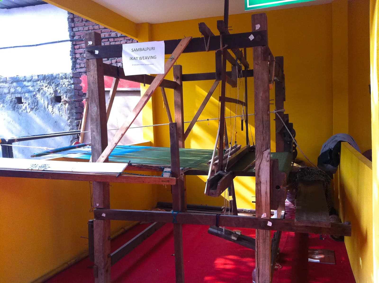 A wooden Sambalpuri ikat handloom (tanta) with yarn set up for weaving in Odisha
