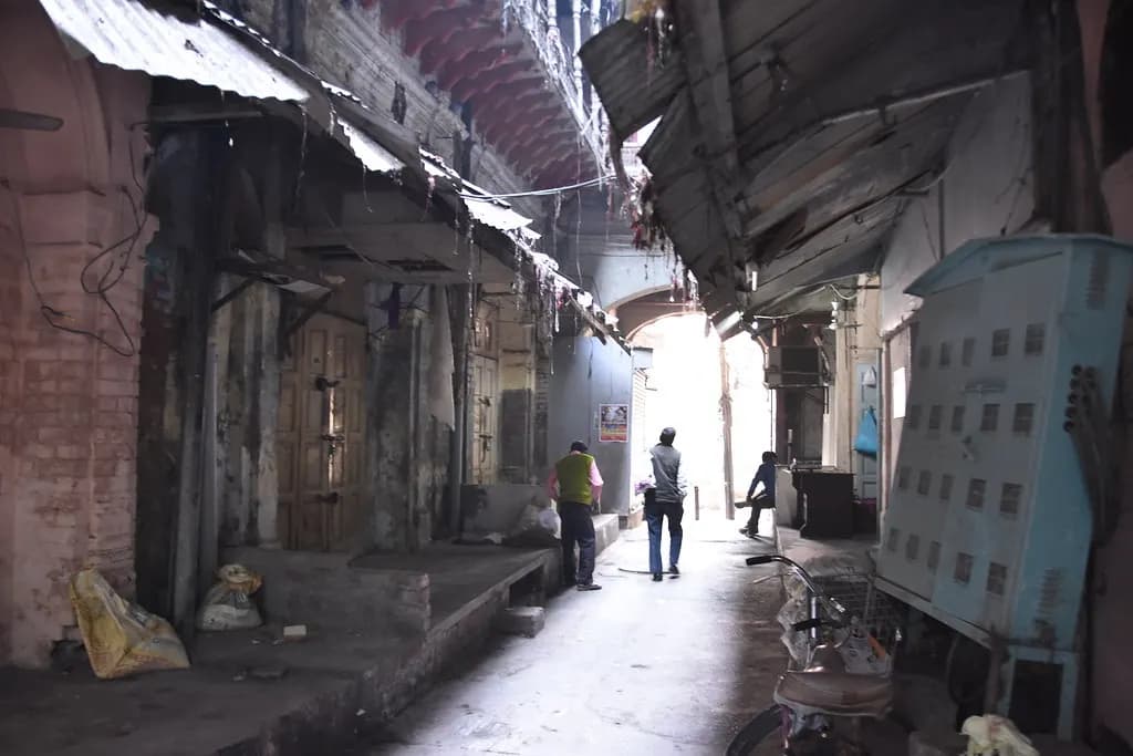 A narrow lane of a wholesale textile market in India with shop shutters down after closing time