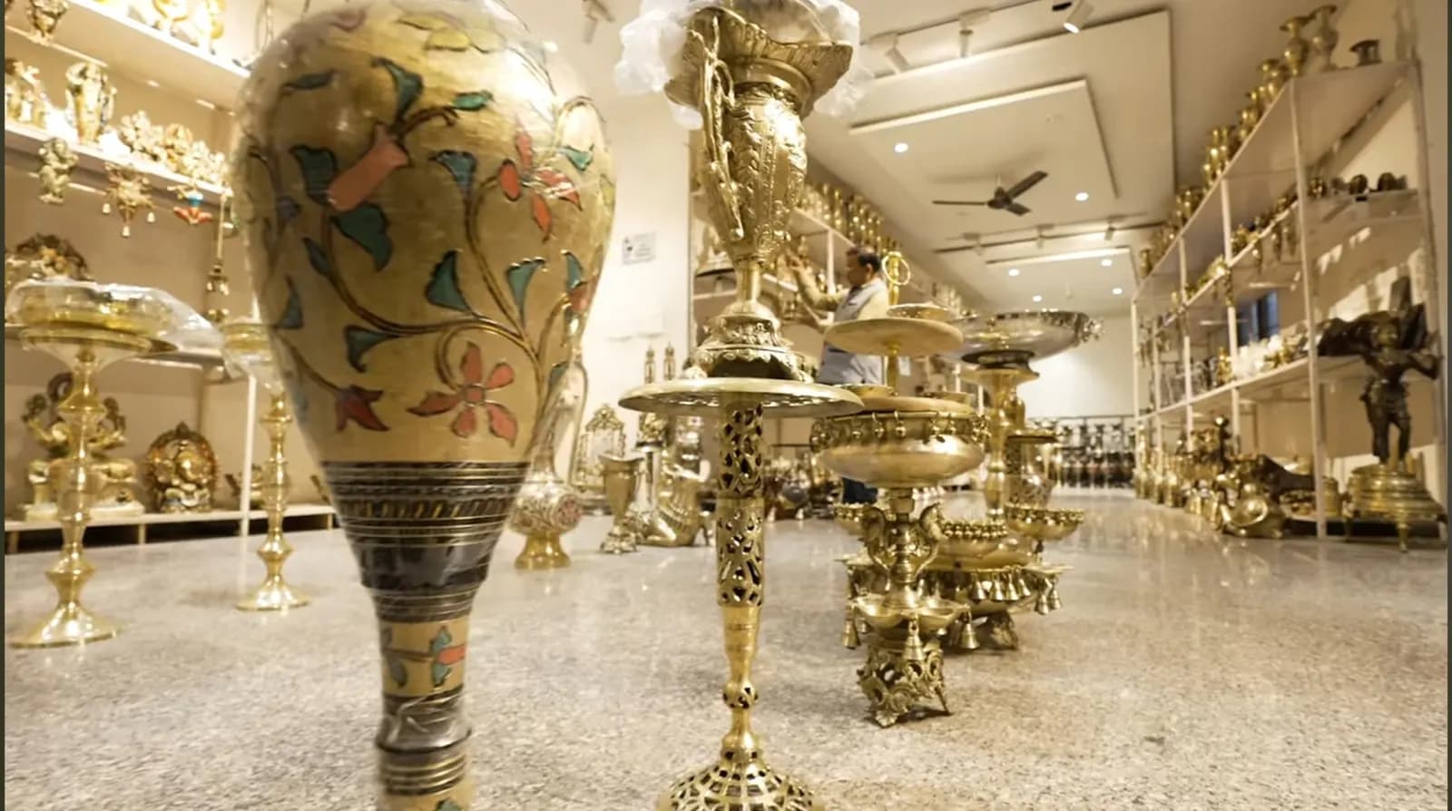 Engraved brass vases, lamps and showpieces on display in a Moradabad brassware showroom